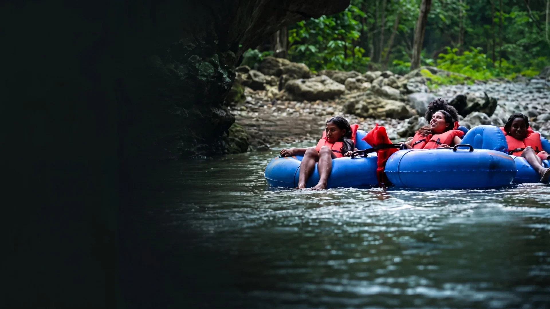 Guests cave tubing on the underground river at Nohoch Che'en in Belize